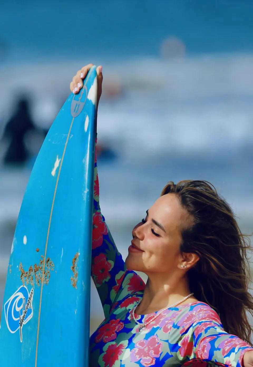 Surf lifestyle portrait with a blue board