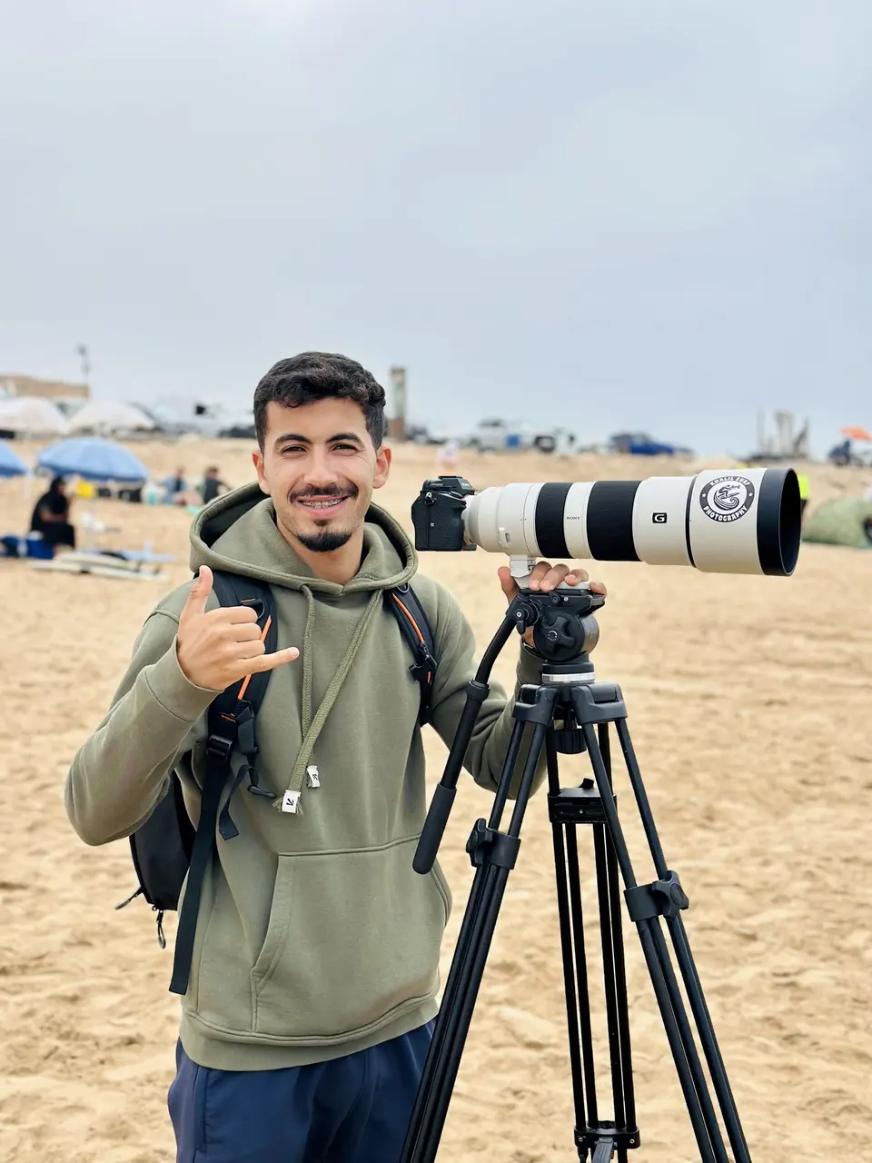 Surf event moment with a photographer and surfer on the beach